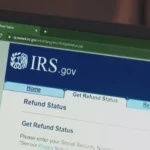 A close-up of a calculator and a tax form showing a higher refund amount than expected.
