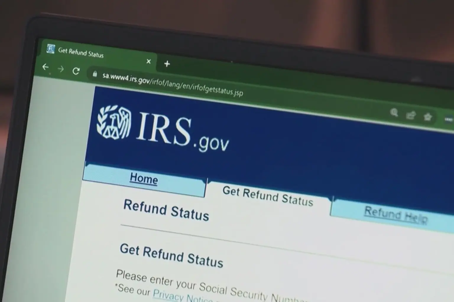 A close-up of a calculator and a tax form showing a higher refund amount than expected.