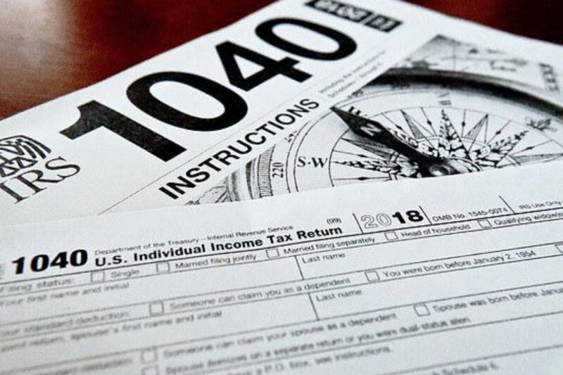 A close-up photograph of a Form 1040 for the 2022 tax year, highlighting the impending April 15 deadline for claiming unclaimed refunds.