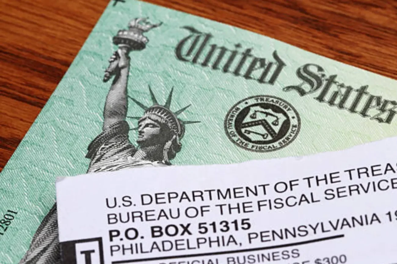 A stressed taxpayer looking at an IRS warning letter about a delayed $2,000 refund.