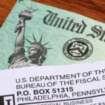 A stressed taxpayer looking at an IRS warning letter about a delayed $2,000 refund.